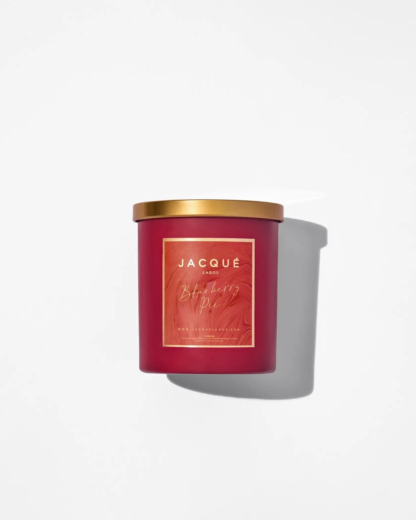 Candle in gold and red container